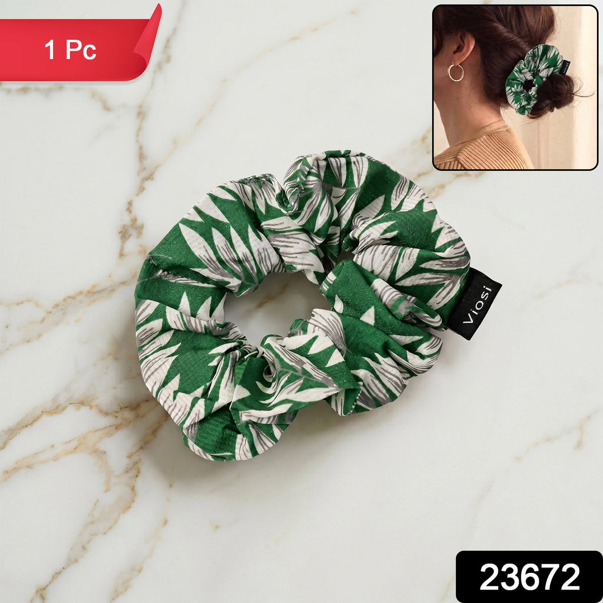 A single green and white leaf print scrunchie with a black 'viosi' tag is on a marble surface, with a '1 Pc' banner and