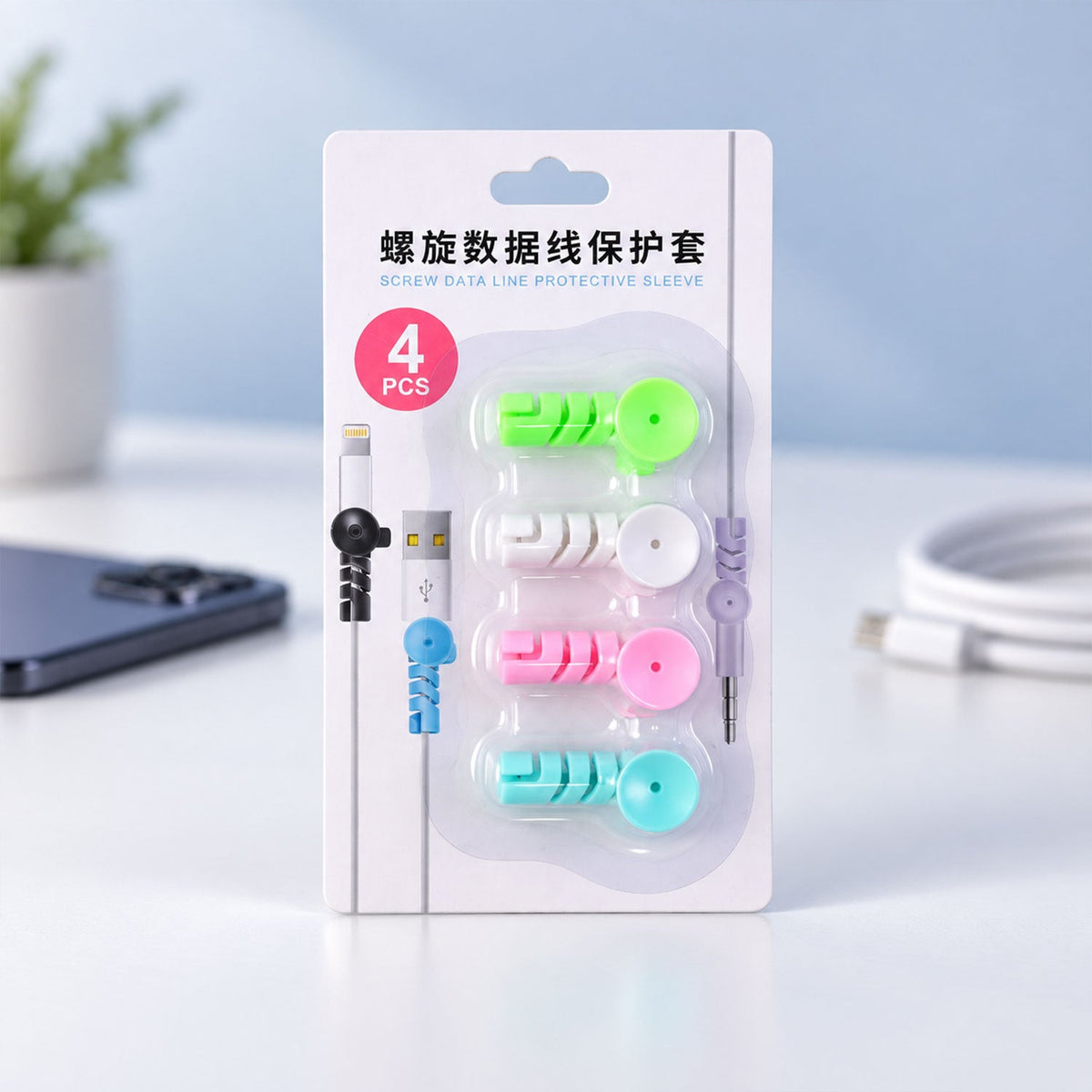 A retail package of four spiral data line protective sleeves in green, white, pink, and blue.