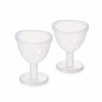 Two identical clear plastic eye wash cups with short stems and wide bases are displayed side-by-side on a plain white