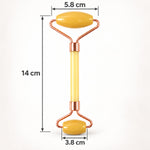 A yellow facial roller with rose gold accents is shown with its dimensions of 14 cm length and roller widths.