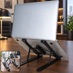 A silver laptop rests on a black adjustable stand, angled upwards on a wooden desk with office background.