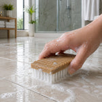 Brush cleaning a bathroom surface