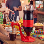 A person dispenses dark soda from an inverted bottle in a red plastic dispenser into a clear cup at a party.