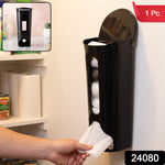 A hand pulls a white plastic bag from the bottom of a black wall-mounted dispenser, full of bags. – view 2