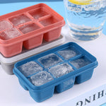 Flexible blue silicone ice tray with 6 grids, filled with water for freezing.