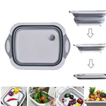 Multi-function foldable chopping board in use for washing vegetables.