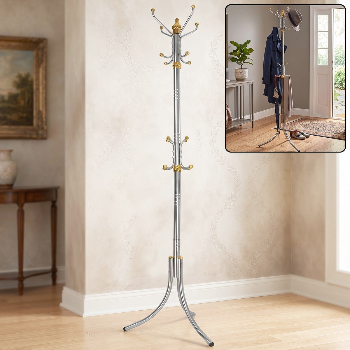 A tall, silver-colored metal clothes hanger stand with gold accents and multiple hooks stands in a room with a painting and
