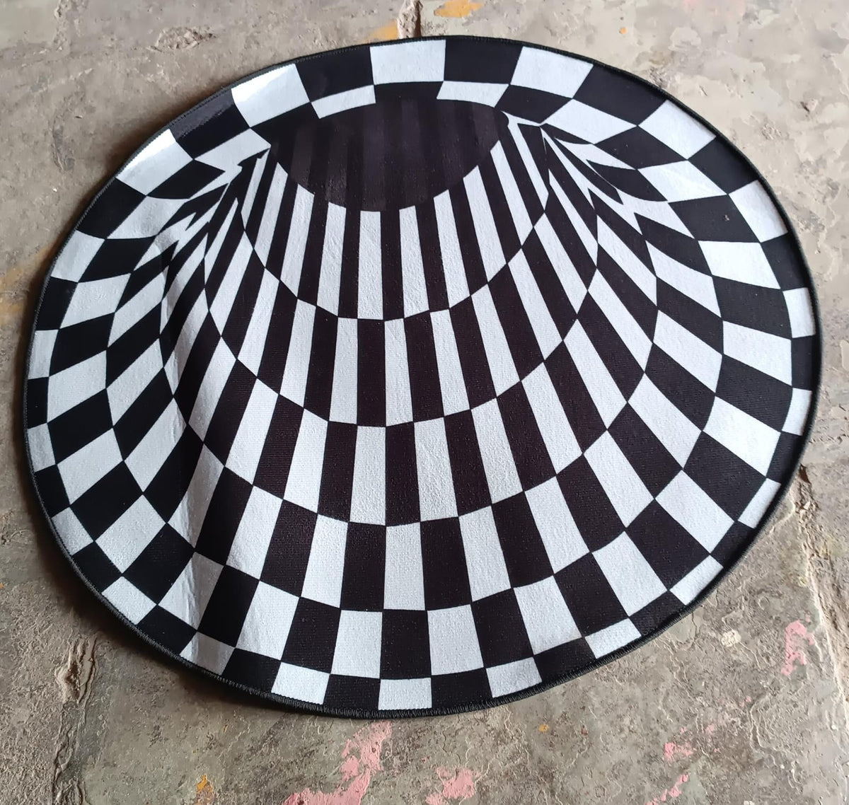 Full view of 3D space round carpet showcasing checkered pattern