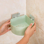 Self adhesive corner shelf installed in a modern bathroom.