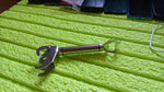 Close-up of the hot bowl holder's handle, revealing its convenient integrated bottle opener.