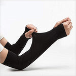 Athlete cycling outdoors wearing black sports arm sleeves, demonstrating active use.