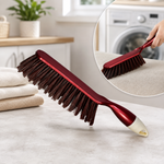 A red and white handled brush with brown bristles rests on a light counter next to folded towels, with an inset showing it