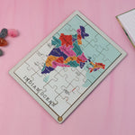 Child's hands actively placing a state piece on the India map puzzle, fostering learning.