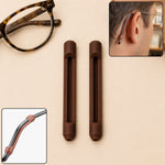 Two brown silicone ear grips next to eyeglasses, with close-ups of a grip on an ear and a temple arm.