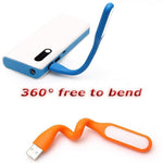 A blue flexible USB LED lamp plugged into a white power bank, and an orange lamp coiled below with text "360° free to bend".