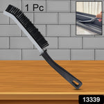 A black and gray crevice cleaning brush stands upright against a gray tiled wall, with an inset showing it cleaning a window