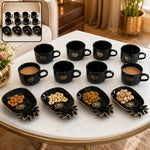 A black ceramic tea set with eight cups and four pineapple-shaped snack bowls, filled with nuts, on a white table.