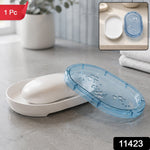 White soap dish with a bar of white soap and a translucent blue lid with butterfly cutouts, in a bathroom setting.