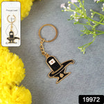 Close-up view of detailed Shivling design on golden metal keychain