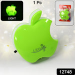 Bright green apple-shaped LED night light with a small inset image of its retail packaging.