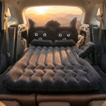 Black cat pillow on inflatable car mattress for comfort