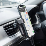 Car phone holder clipped to the air vent with a phone in place