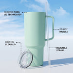 A mint green tumbler with its clear lid and straw detached, showing features like quarter-turn lid technology.