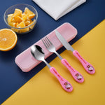 Pink Hello Kitty spoon, knife, fork, and case on a blue and yellow background with oranges.