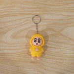 In-use image of face-changing doll keychain attached to backpack