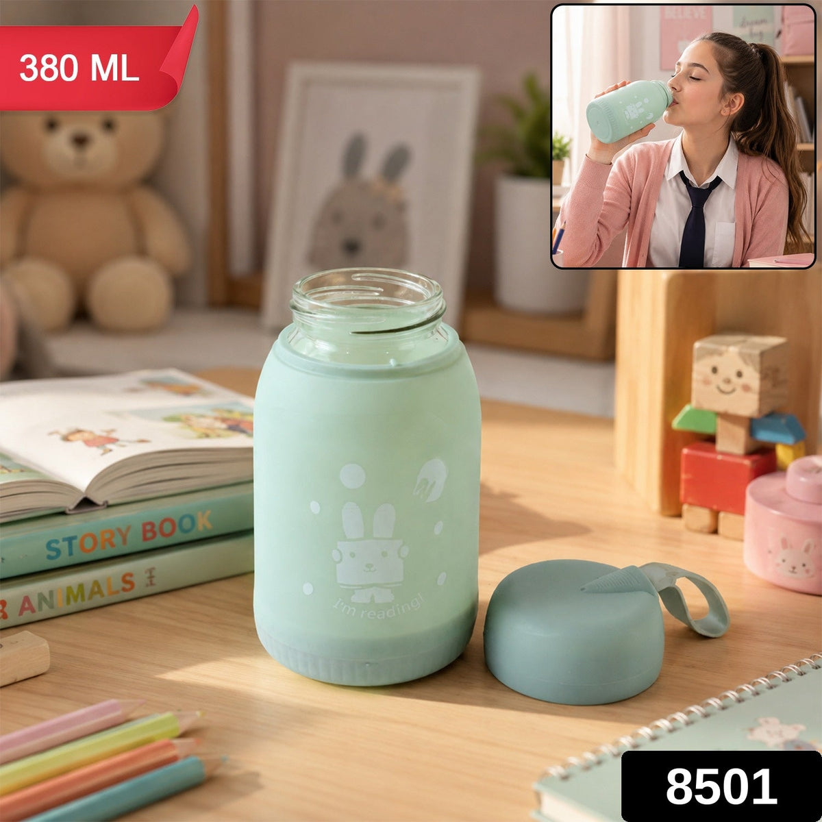 A mint green glass bottle with a bunny print sits on a desk, with a matching lid beside it. The bottle is labeled 380 ML and