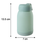 A mint green glass bottle with a bunny print is shown with its dimensions: 13.5 cm tall and 7 cm wide.