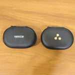A black oval hard shell charging cable and adapter storage case (1 Pc) is shown closed with a gold three-dot logo.