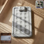 Portable inflatable bed folded for storage with easy carrying handle