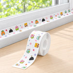 A roll of cartoon-printed sealing tape sits on a wooden windowsill, with the tape extending along the window frame.