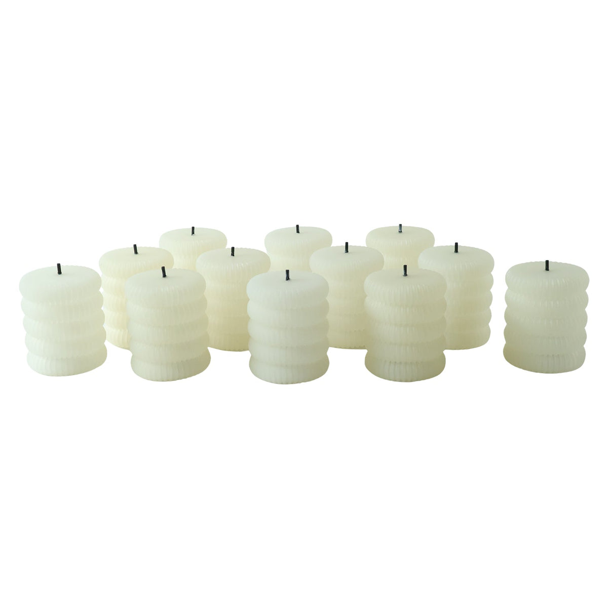 A group of twelve unlit cream ribbed LED candles with black wicks are scattered on a white background.