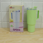 A light green travel tumbler with a handle, lid, and straw is displayed next to its product box on a wooden surface.