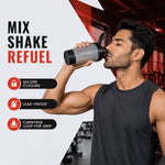 A man in a black tank top drinks from a grey and black shaker bottle in a gym, with text "MIX SHAKE REFUEL" and feature