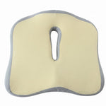 Top-down view of a beige and grey ergonomic seat cushion with a central cutout.