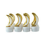 Eight golden crescent moon LED tealights on a white background, unlit and in two rows.