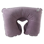 An inflated purple velvet U-shape neck pillow with a dark trim and a clear valve, on a white background.