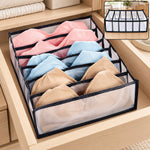 A 6-section drawer organizer filled with pink, blue, and beige bras sits inside a light wooden drawer. – view 8