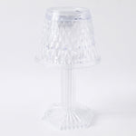 Modern LED crystal lamp displayed on a wooden shelf in a home setting.