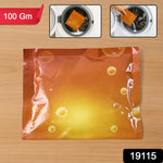 An orange powder sachet on wood, with two inset images showing it being placed into a washing machine drum.