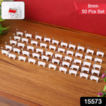 Fifty white plastic cable clips with nails arranged in neat rows on a wooden surface, with a small bag of clips in the top