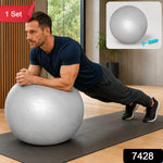 A man in a navy t-shirt and dark pants holds a plank position with his forearms on a grey stability ball. A small – view 2