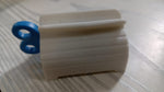 Plastic tube squeezer with its seat holder, emphasizing convenience and organization for bathroom essentials.