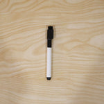 Black dry erase marker in use on a whiteboard