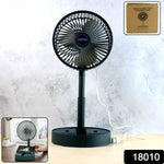 Foldable USB desk fan placed next to a phone on office table