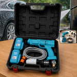 Open black carrying case revealing a teal pressure washer, two batteries, hose, and attachments on a wooden surface.