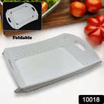 A white foldable serving tray is shown partially folded, with vegetables in the background.